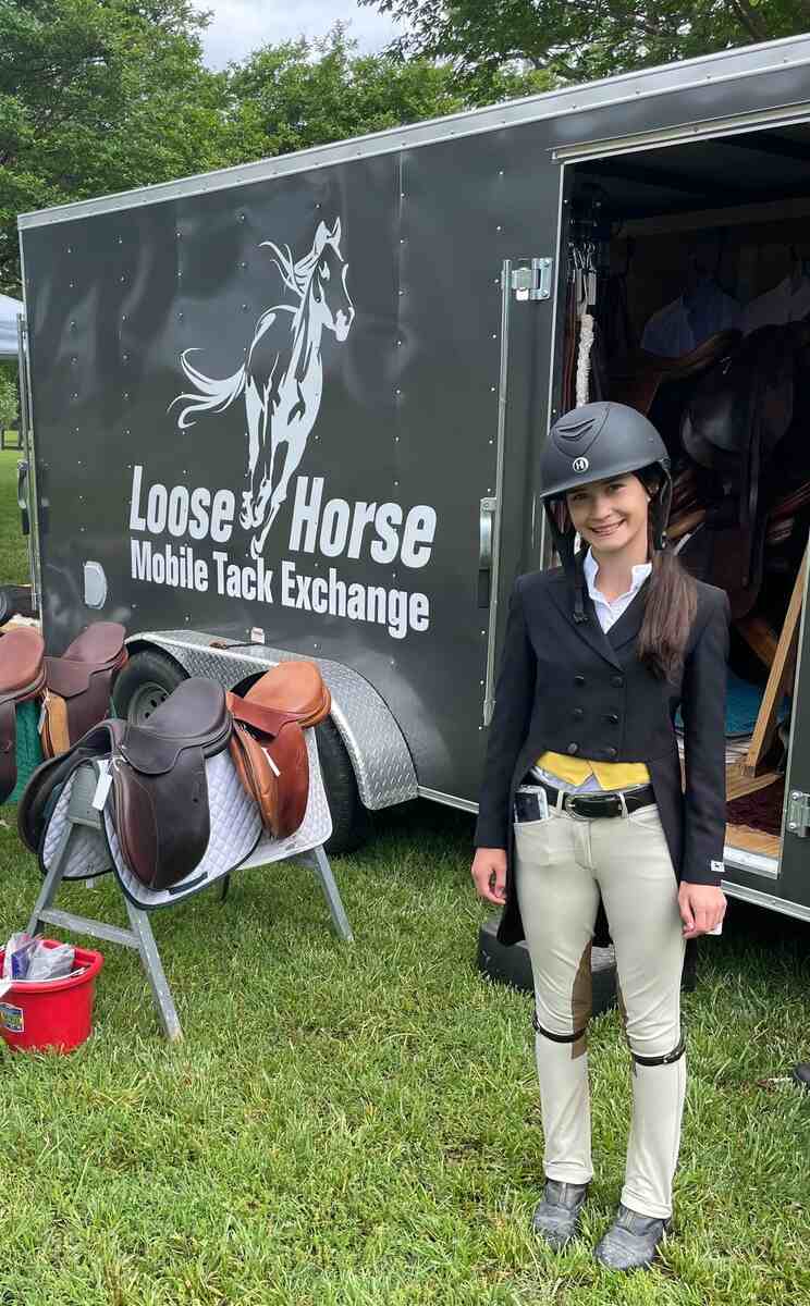 Girsl with tailcoat at trailer